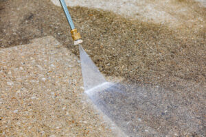 A pressure washer cleaning concrete in El Paso.